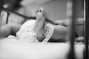 Close up shot of newborn baby's leg.