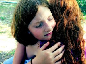 Sad child hugging their mother after dealing with rude questions.